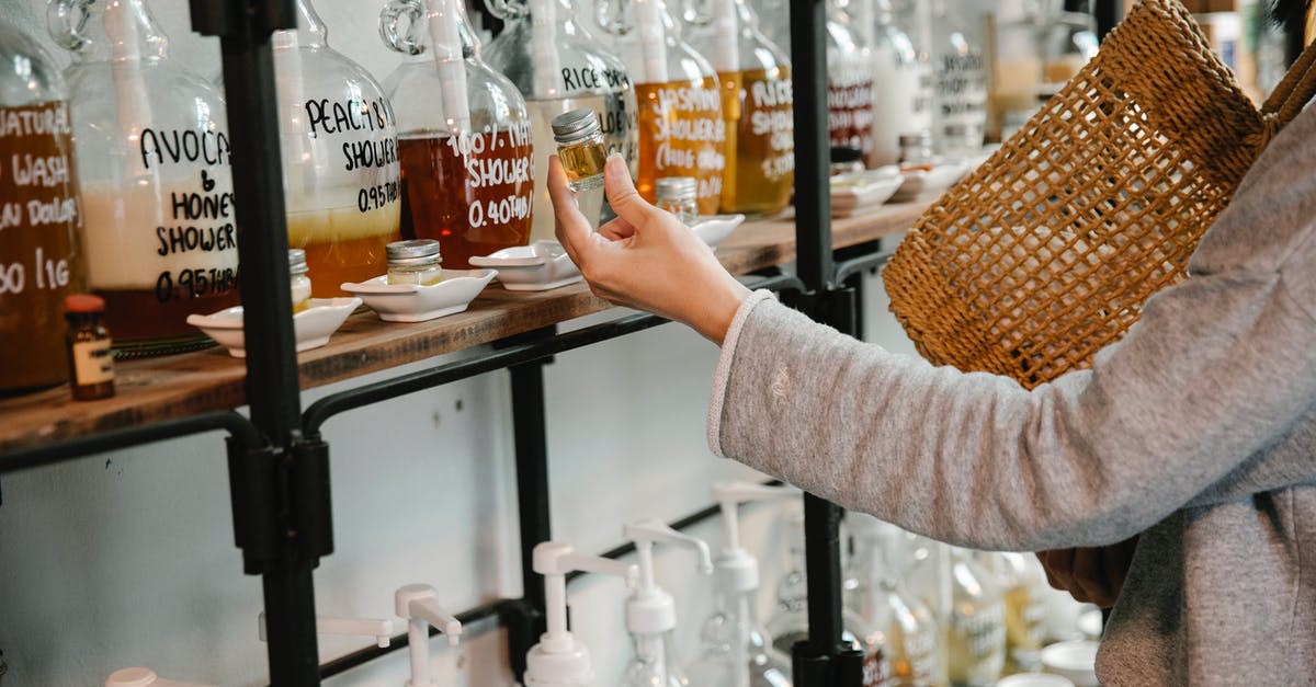 What everyday ingredient will emulsify rapeseed oil? - Crop customer examining glass jar with shampoo in market while standing near big dispensers placed on wooden shelves What everyday ingredient will emulsify rapeseed oil? - Crop customer examining glass jar with shampoo in market while standing near big dispensers placed on wooden shelves