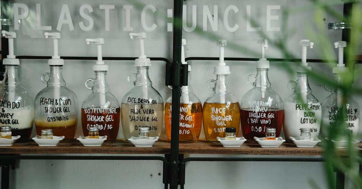 What everyday ingredient will emulsify rapeseed oil? - Raw of dispensers with multicolored shower gel and lotion placed near glass jars in white saucers on wooden shelf What everyday ingredient will emulsify rapeseed oil? - Raw of dispensers with multicolored shower gel and lotion placed near glass jars in white saucers on wooden shelf