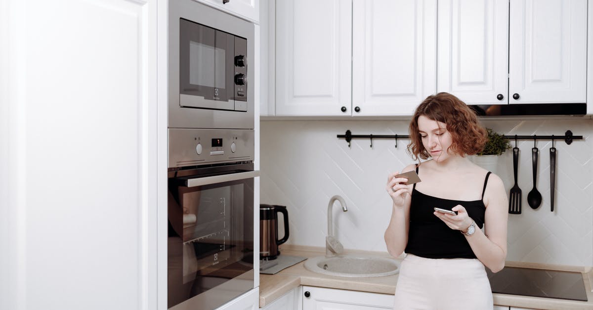 What factors should I consider when buying kitchen tongs? - Woman Leaning on a Kitchen Counter What factors should I consider when buying kitchen tongs? - Woman Leaning on a Kitchen Counter