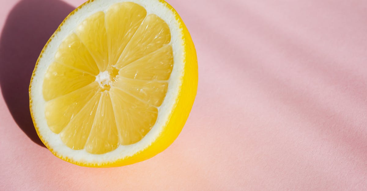 What flavorings do you use for sour pickles? - From above half of fresh sliced lemon placed in pink background in bright sunlight What flavorings do you use for sour pickles? - From above half of fresh sliced lemon placed in pink background in bright sunlight