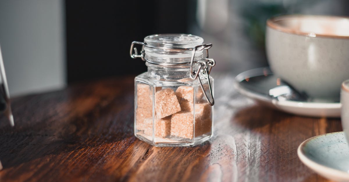 What food can contain a hot drink? - Clear Condiment Shaker With Brown Sugar Cubes Near Gray Teacup What food can contain a hot drink? - Clear Condiment Shaker With Brown Sugar Cubes Near Gray Teacup