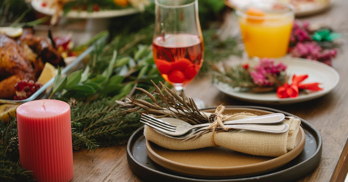 What gives Vietnamese Chicken the red tint? - Delicious dinner with roasted chicken served on table with Christmas decorations What gives Vietnamese Chicken the red tint? - Delicious dinner with roasted chicken served on table with Christmas decorations
