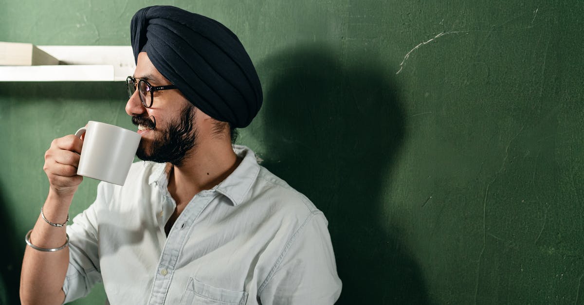 What green tea has the highest caffeine content? - Happy man in turban drinking hot beverage What green tea has the highest caffeine content? - Happy man in turban drinking hot beverage