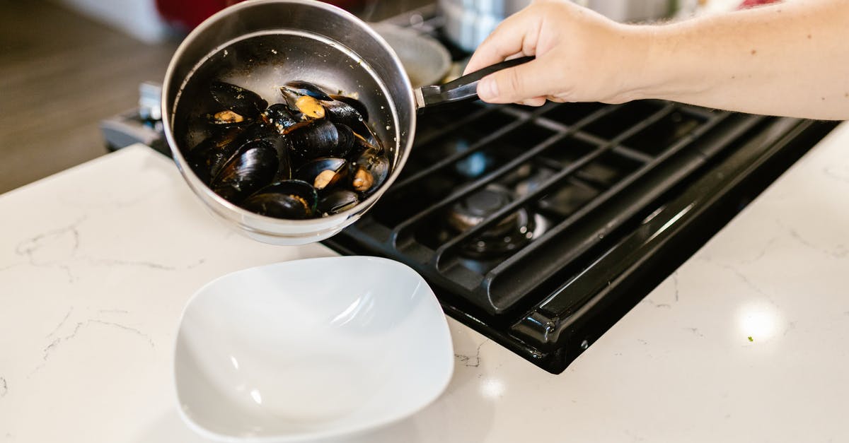 What happened, when I boiled this pot dry? - Hand Holding Pot with Boiled Mussels What happened, when I boiled this pot dry? - Hand Holding Pot with Boiled Mussels