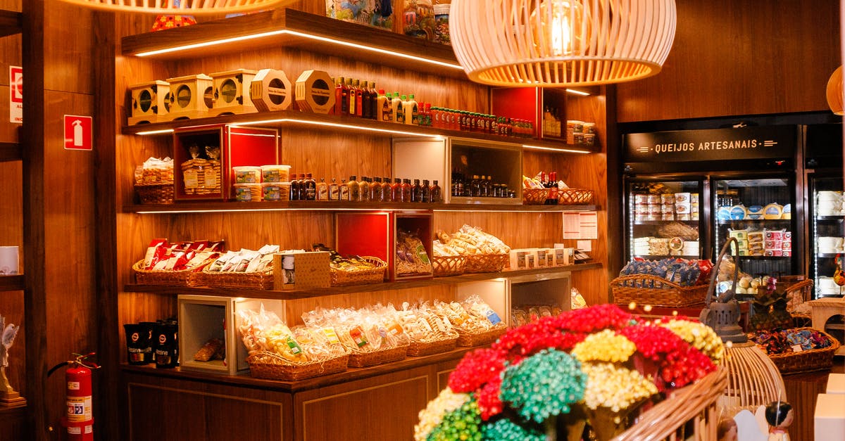 What happens when I store coffee in the refrigerator? - Modern store with collection of tea and snacks near bottles of sauces illuminated by lamp What happens when I store coffee in the refrigerator? - Modern store with collection of tea and snacks near bottles of sauces illuminated by lamp