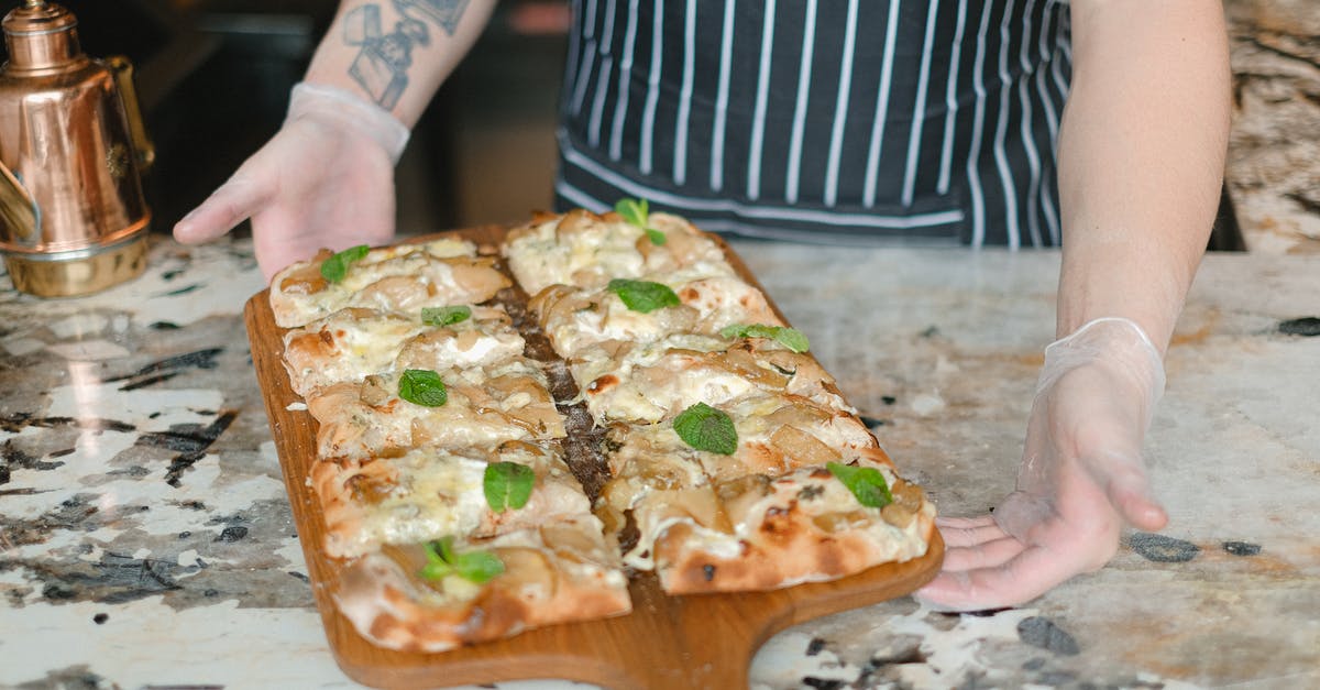 What herbs to use when baking bread, rusks and scones? - A Person Holding a Tray Pizza With Mint Leaves Toppings What herbs to use when baking bread, rusks and scones? - A Person Holding a Tray Pizza With Mint Leaves Toppings