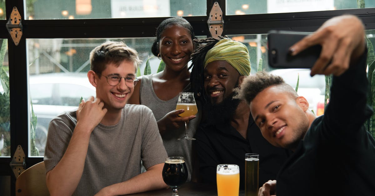 What I can use to replace black beer on roast recipe? - Happy multiethnic friends taking selfie on smartphone in cafe
