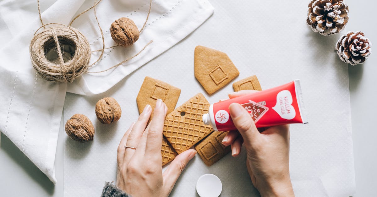 What impact does the order of assembly have when making cookies? - A Person Assembling a Gingerbread House Cookie