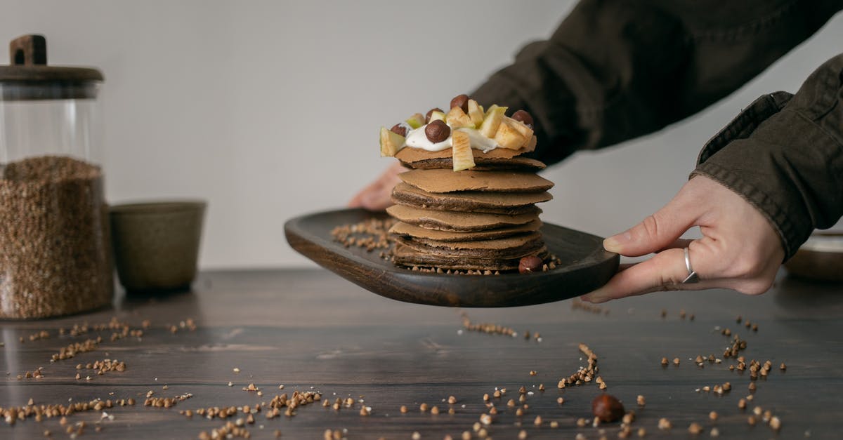 What ingredients do Bernaise sauce and fruit smoothies have in common? - Unrecognizable woman with tasty pancakes