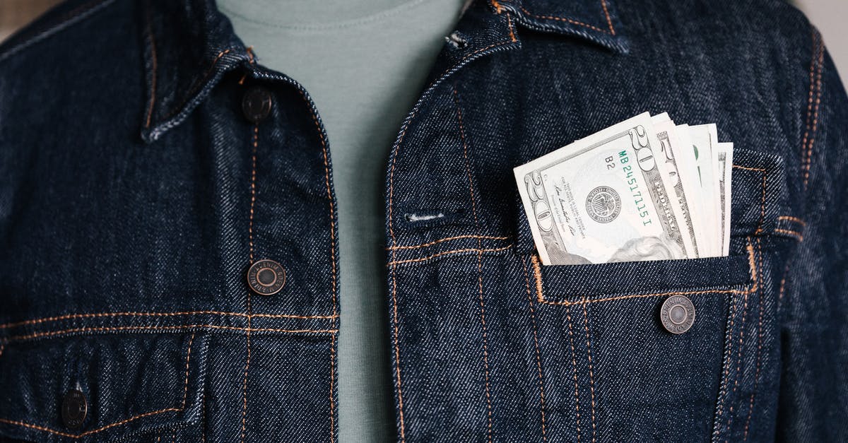 What international cooking terms sound similar but have different meanings? - Crop unrecognizable male in casual outfit standing with different nominal pars of dollar banknotes in pocket of jeans jacket What international cooking terms sound similar but have different meanings? - Crop unrecognizable male in casual outfit standing with different nominal pars of dollar banknotes in pocket of jeans jacket