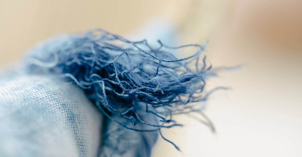 what is a loose spice? - Closeup of colorful loosen threads of natural blue textile hung on clothesline on blurred background what is a loose spice? - Closeup of colorful loosen threads of natural blue textile hung on clothesline on blurred background