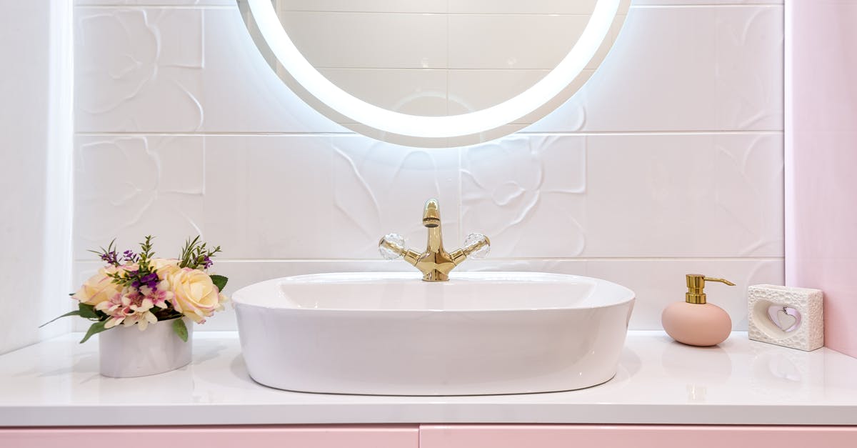 What is a mild detergent? - Interior of modern bathroom with luminous mirror hanging under sink with faucet near blooming flowers and soap What is a mild detergent? - Interior of modern bathroom with luminous mirror hanging under sink with faucet near blooming flowers and soap