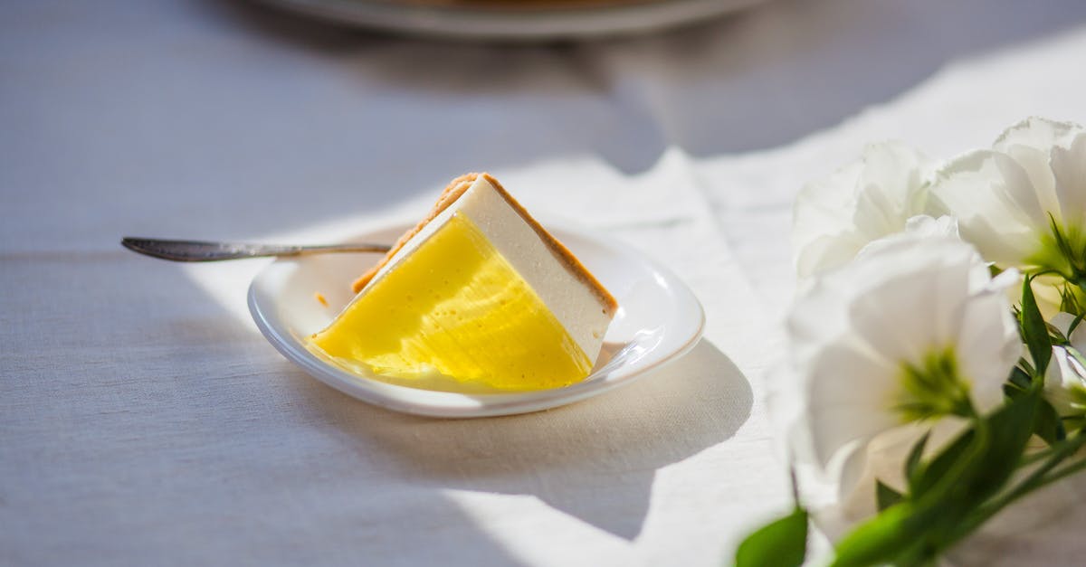 What is better for chilled cheesecake - pectin or gelatin? - Tasty cheesecake near decorative flowers on table What is better for chilled cheesecake - pectin or gelatin? - Tasty cheesecake near decorative flowers on table