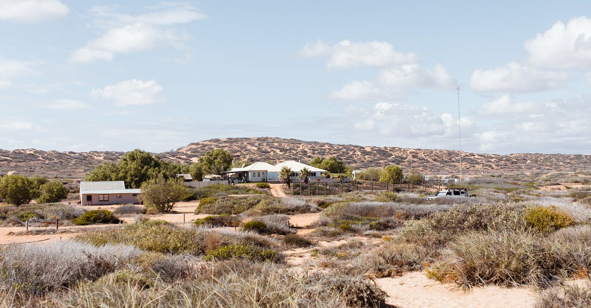 What is dry cottage cheese? - Distant buildings located on dry area with green shrubs against hills in semidesert terrain in rural settlement against cloudy sky What is dry cottage cheese? - Distant buildings located on dry area with green shrubs against hills in semidesert terrain in rural settlement against cloudy sky