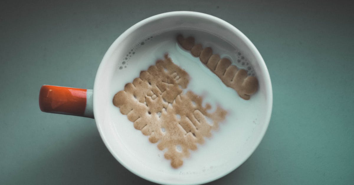 What is it about milk that makes it go well with cookies? [closed] - White Mug Filled White With Milk and Brown Biscuit