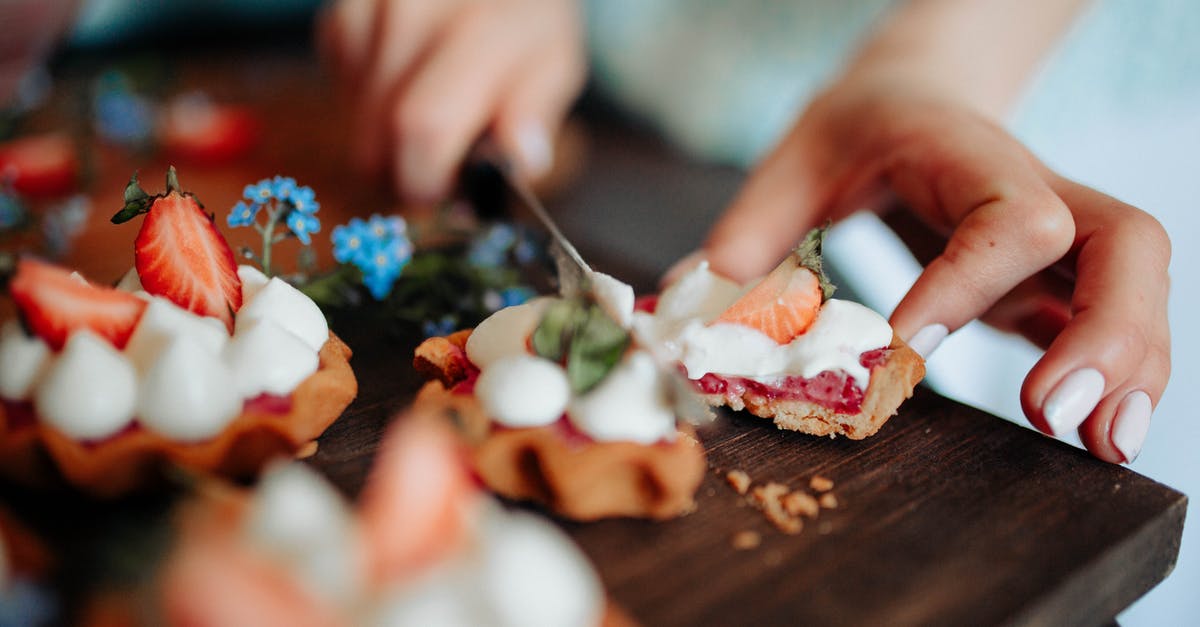 What is Light Cream - Unrecognizable woman cutting delicious dessert What is Light Cream - Unrecognizable woman cutting delicious dessert