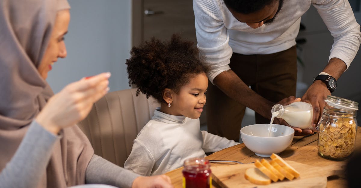 What is milk classified as once you pour it on cereal? - Cheerful diverse family having breakfast with milk and cereals What is milk classified as once you pour it on cereal? - Cheerful diverse family having breakfast with milk and cereals