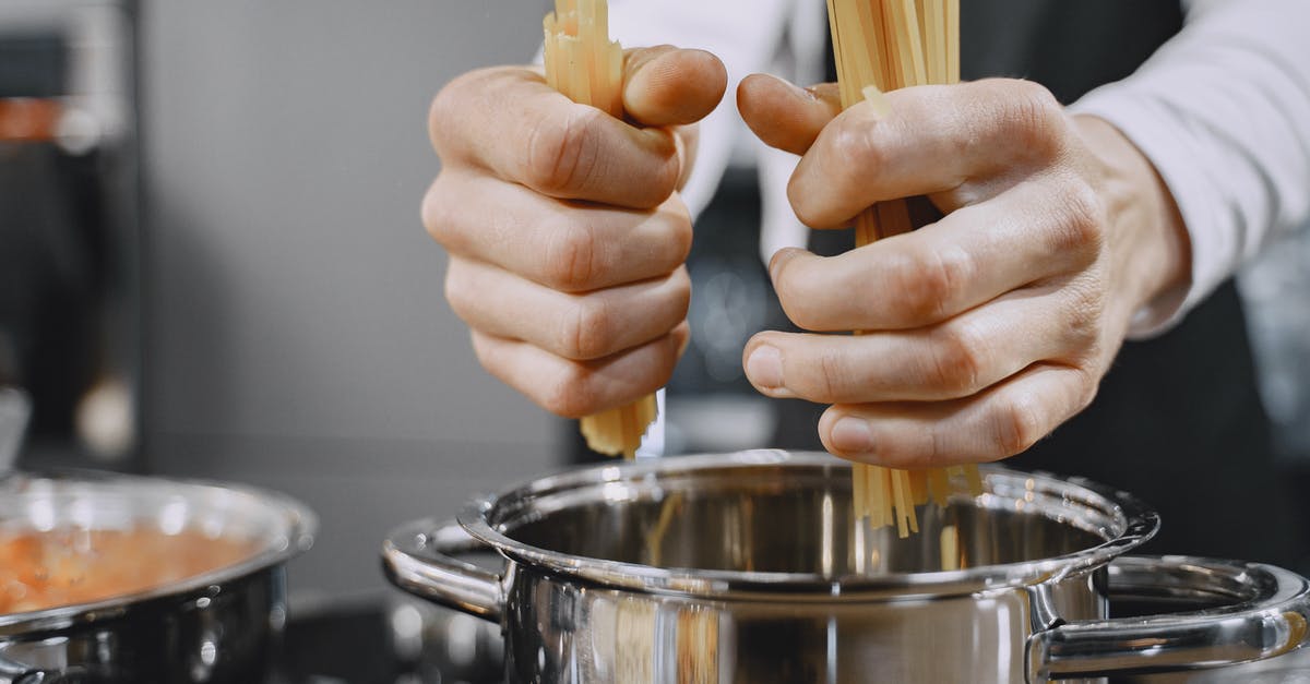 What is the benefit of a pasta pot with an inset? - Person putting Pasta on a Stainless Pot What is the benefit of a pasta pot with an inset? - Person putting Pasta on a Stainless Pot