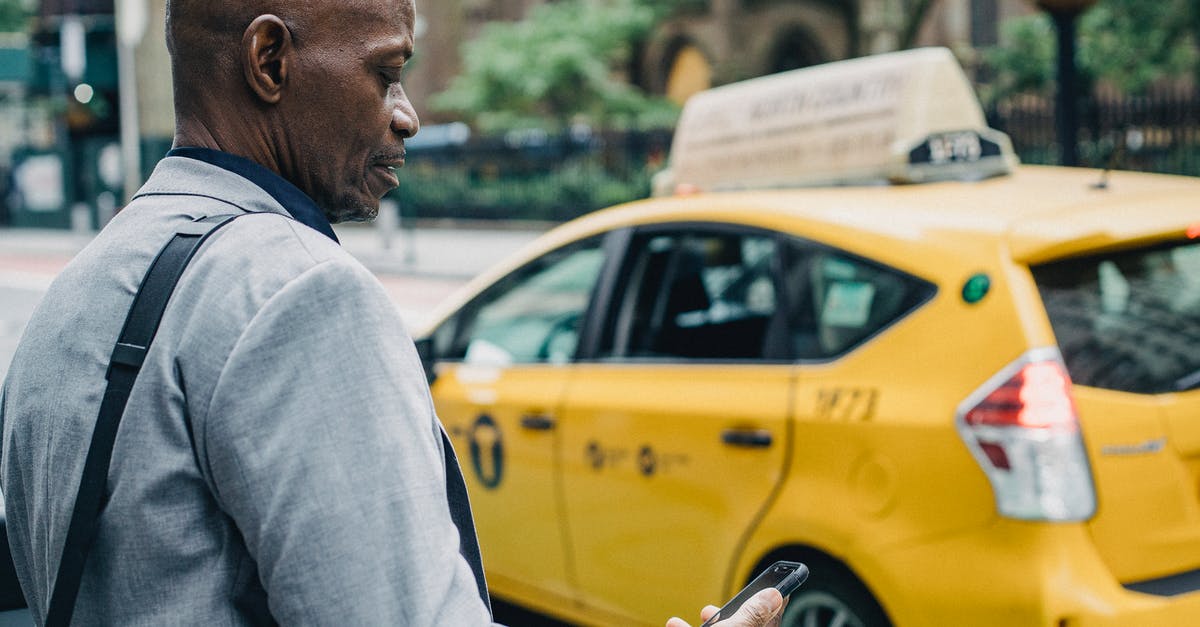 What is the danger in cross contamination? - Busy black businessman checking notification on smartphone while crossing street