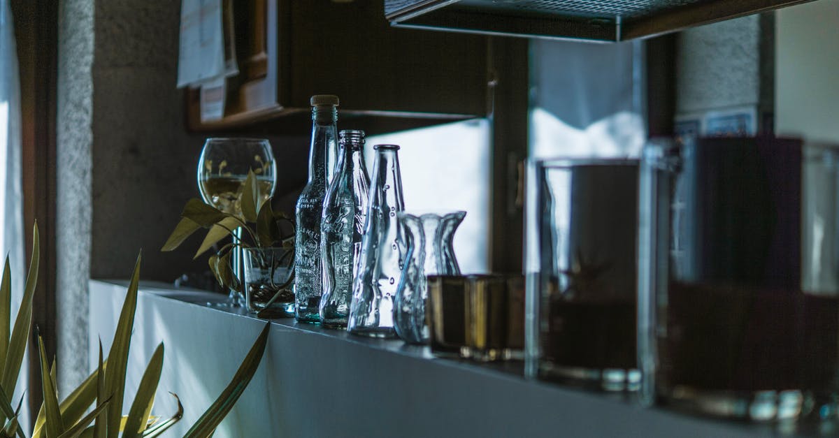 What is the dark stuff inside a green bell pepper? - Assorted Clear Glass Bottles With Wine Glass in the Shelf What is the dark stuff inside a green bell pepper? - Assorted Clear Glass Bottles With Wine Glass in the Shelf