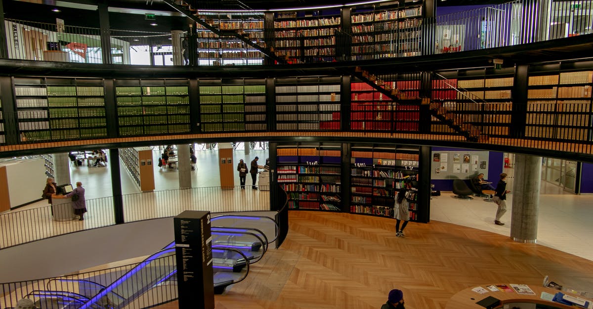 What is the difference between Clam Chowder and New England style? - People in modern library with books