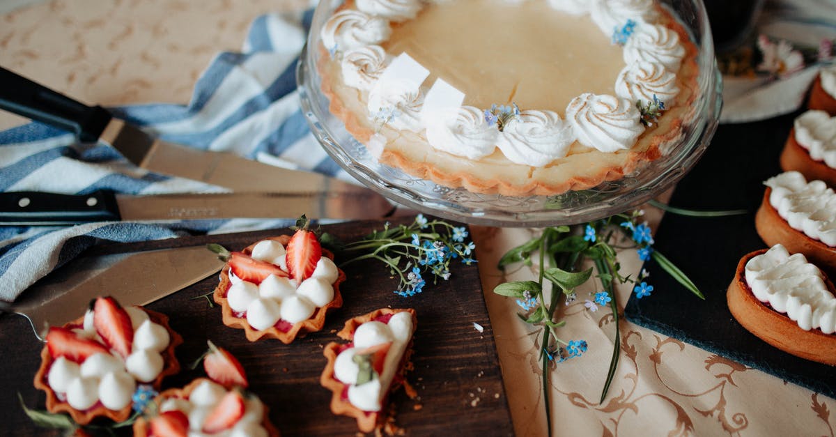 What is the difference between Dutch Pie and German Pie? - Pie decorated with cream on tray with glass cap near flowers and different desserts on cutting boards near knives on table in bright kitchen What is the difference between Dutch Pie and German Pie? - Pie decorated with cream on tray with glass cap near flowers and different desserts on cutting boards near knives on table in bright kitchen