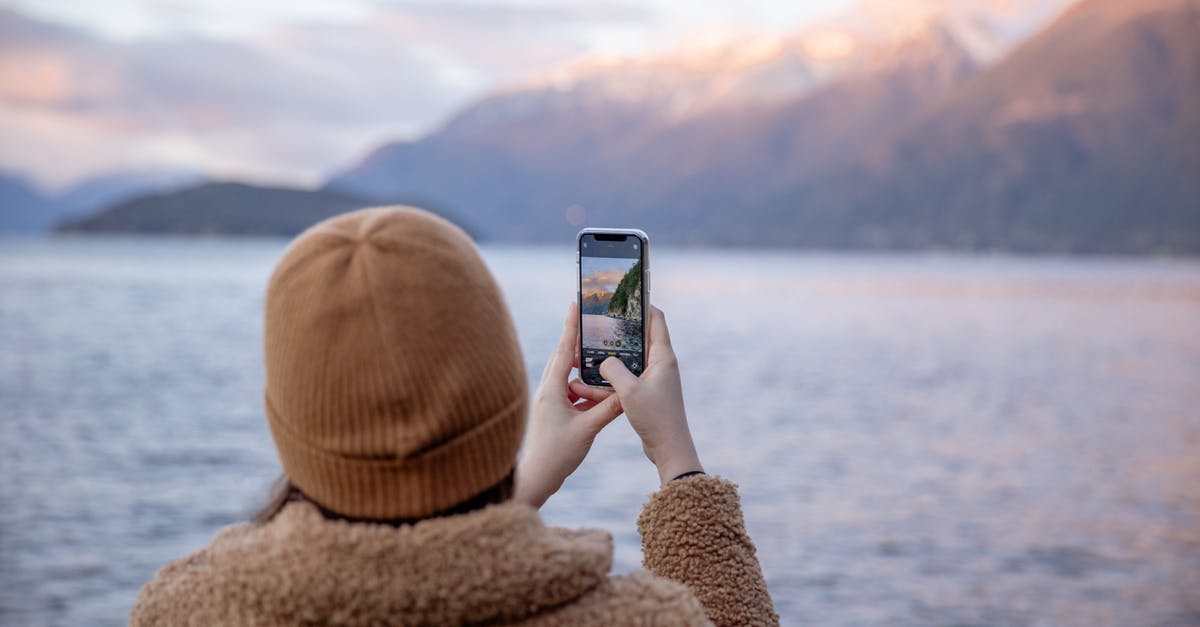 What is the difference between using hot water and cold water when making regular pastry? - Unrecognizable female traveler taking photo of lake and mountains