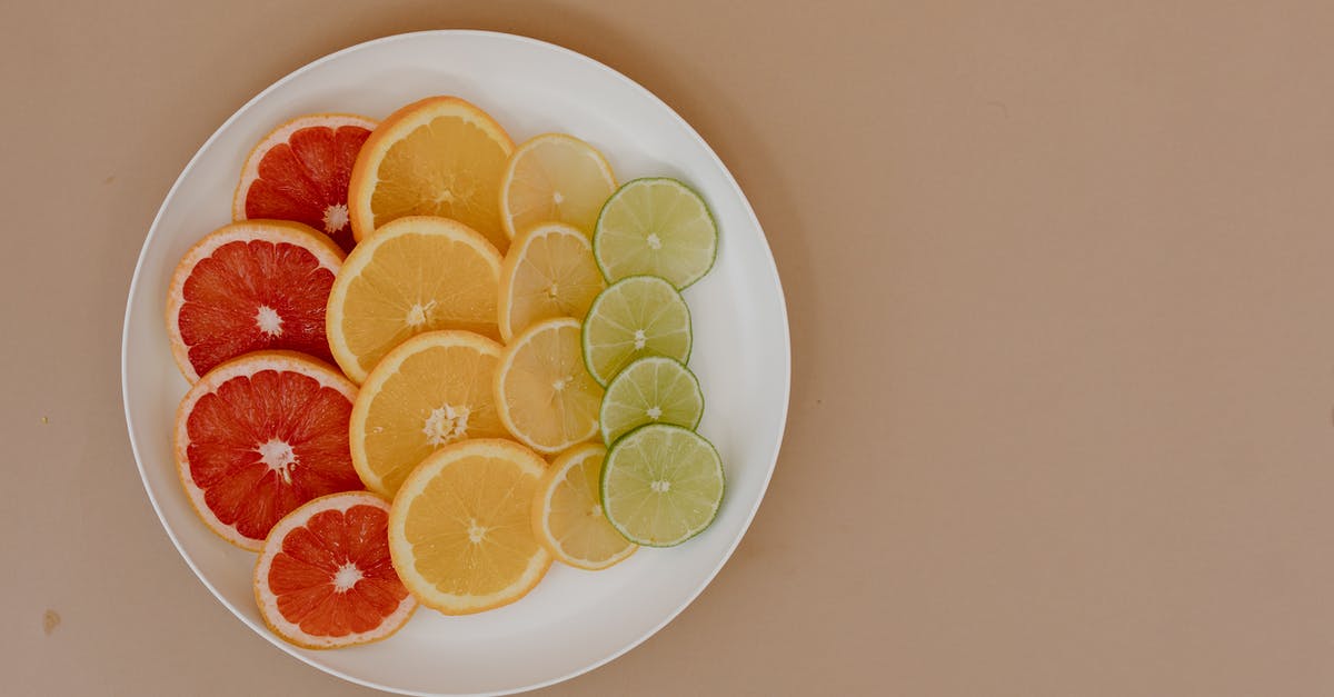 What is the difference in flavour between the zest of an orange vs lemon vs lime - Top view of sliced red grapefruits with yellow lemons near oranges and green limes on plates in light place on beige surface What is the difference in flavour between the zest of an orange vs lemon vs lime - Top view of sliced red grapefruits with yellow lemons near oranges and green limes on plates in light place on beige surface