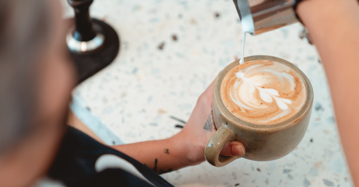 What is the foam that comes out when making clarified butter? - Photo of Barista Pouring Milk on Latte What is the foam that comes out when making clarified butter? - Photo of Barista Pouring Milk on Latte