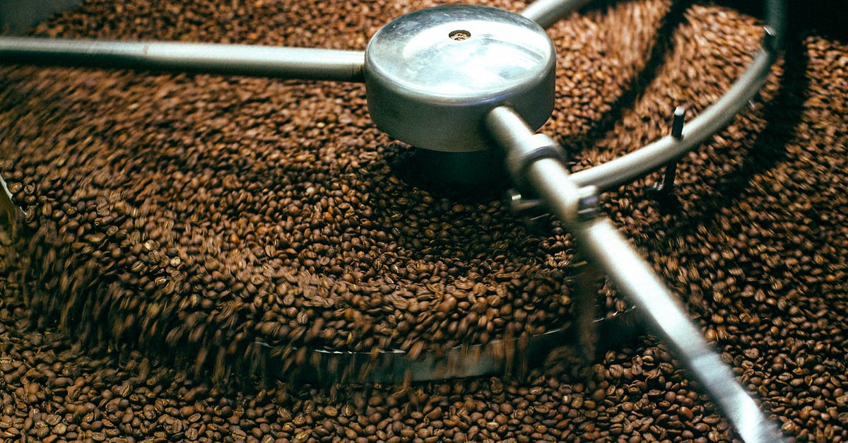 What is the ideal grind for making espresso? - From above of fresh aromatic brown coffee beans mixing in professional roasting machine What is the ideal grind for making espresso? - From above of fresh aromatic brown coffee beans mixing in professional roasting machine