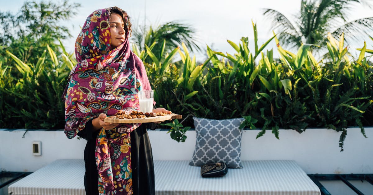 What is the milk in Bratwurst for? - Woman in Black and Pink Floral Dress Holding White Tray With Food