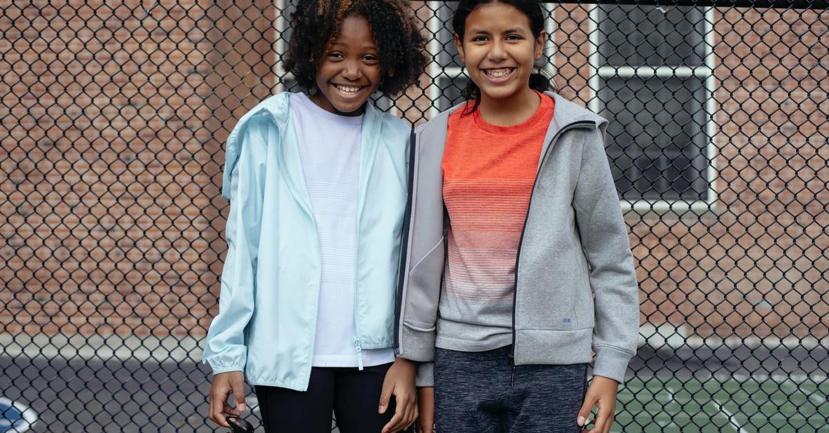 What is the net (absorbable) carb content of Psyllium Husk? [closed] - Cheerful multiracial athletes in sportswear standing together near metal net fence and looking at camera