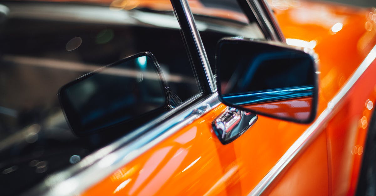 What is the orange part on a scallop? - Side mirror and door of orange red old timer automobile glistening in electric lights of garage What is the orange part on a scallop? - Side mirror and door of orange red old timer automobile glistening in electric lights of garage