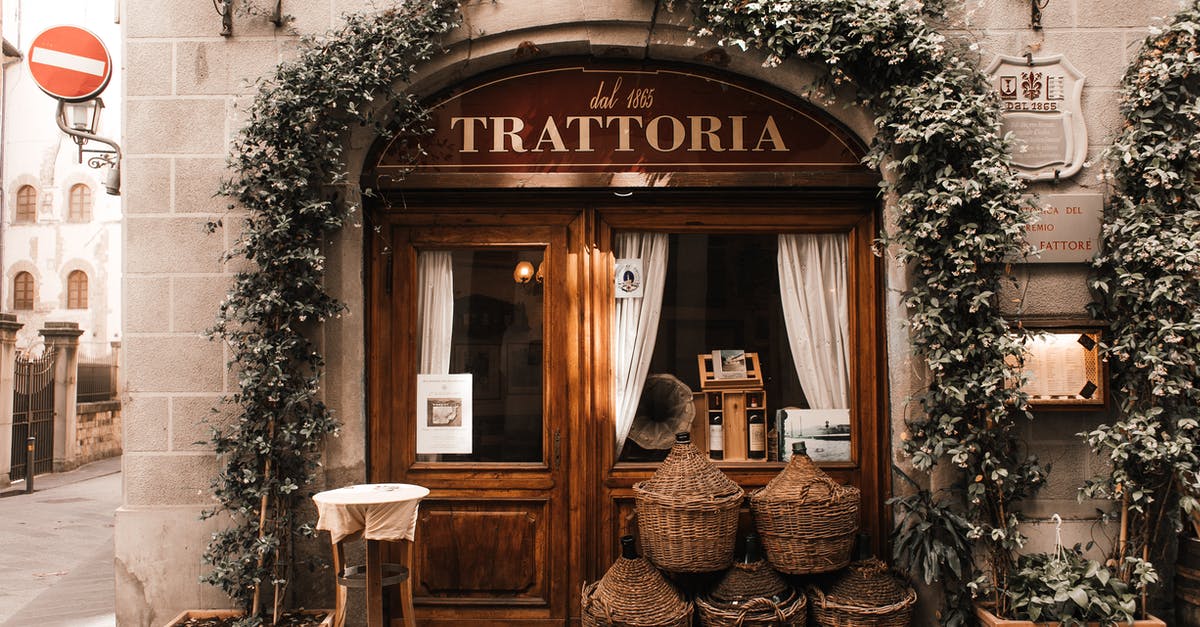 What is the place called where cheese is aged? - Exterior of cozy Italian restaurant with wooden door and entrance decorated with plants What is the place called where cheese is aged? - Exterior of cozy Italian restaurant with wooden door and entrance decorated with plants