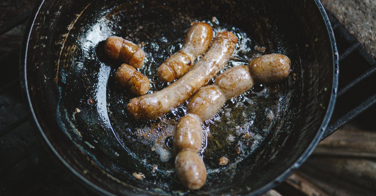 What is the point of frying and then poaching a sausage? - Sausages in a Black Wok What is the point of frying and then poaching a sausage? - Sausages in a Black Wok