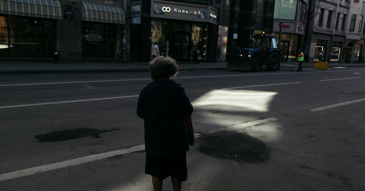 What is the proper way to brine fish? - Full body back view of anonymous male standing on empty asphalt roadway on street with showcases in buildings in city with sunbeam What is the proper way to brine fish? - Full body back view of anonymous male standing on empty asphalt roadway on street with showcases in buildings in city with sunbeam