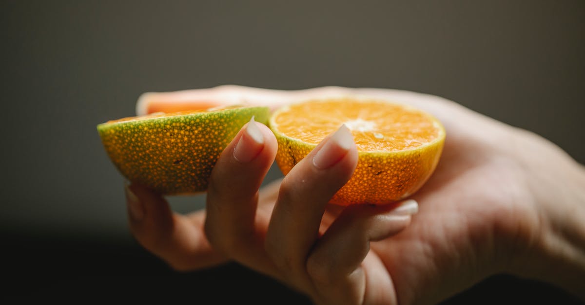 What is the rate of loss of vitamin C in fresh vegetables? - Crop faceless woman showing halves of fresh orange with juicy pulp for healthy diet What is the rate of loss of vitamin C in fresh vegetables? - Crop faceless woman showing halves of fresh orange with juicy pulp for healthy diet