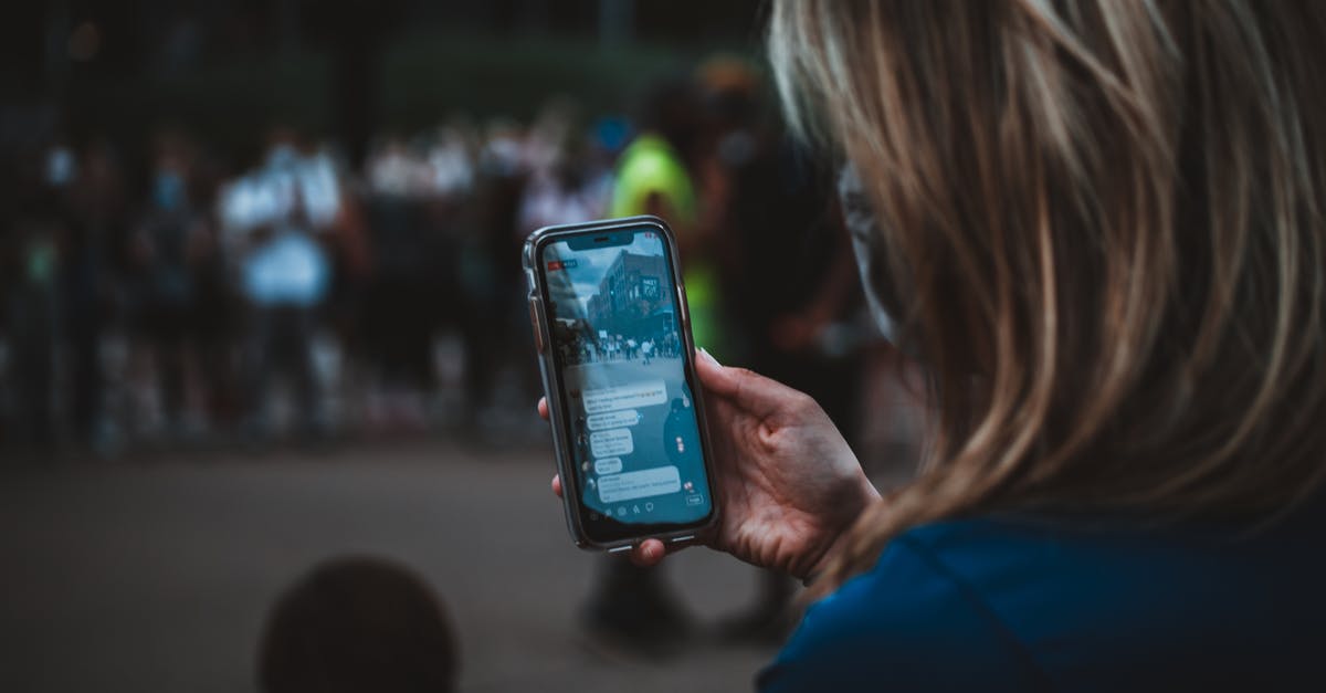What is the right use of bake and broil? - Crop woman with smartphone near protesters during manifestation What is the right use of bake and broil? - Crop woman with smartphone near protesters during manifestation