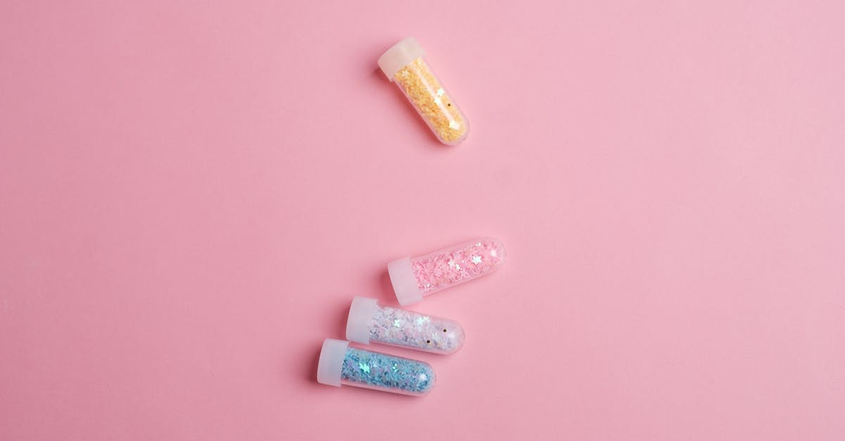 What is the science behind Magic Cake? - Top view of glass tubes filled with colorful sparkling star shaped glitter scattered on pink table What is the science behind Magic Cake? - Top view of glass tubes filled with colorful sparkling star shaped glitter scattered on pink table