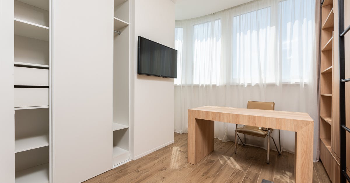 What is the shelf life of opened cheeses? - Chair at wooden table near wall with window and TV between opened empty wardrobes in spacious room with minimalist interior What is the shelf life of opened cheeses? - Chair at wooden table near wall with window and TV between opened empty wardrobes in spacious room with minimalist interior