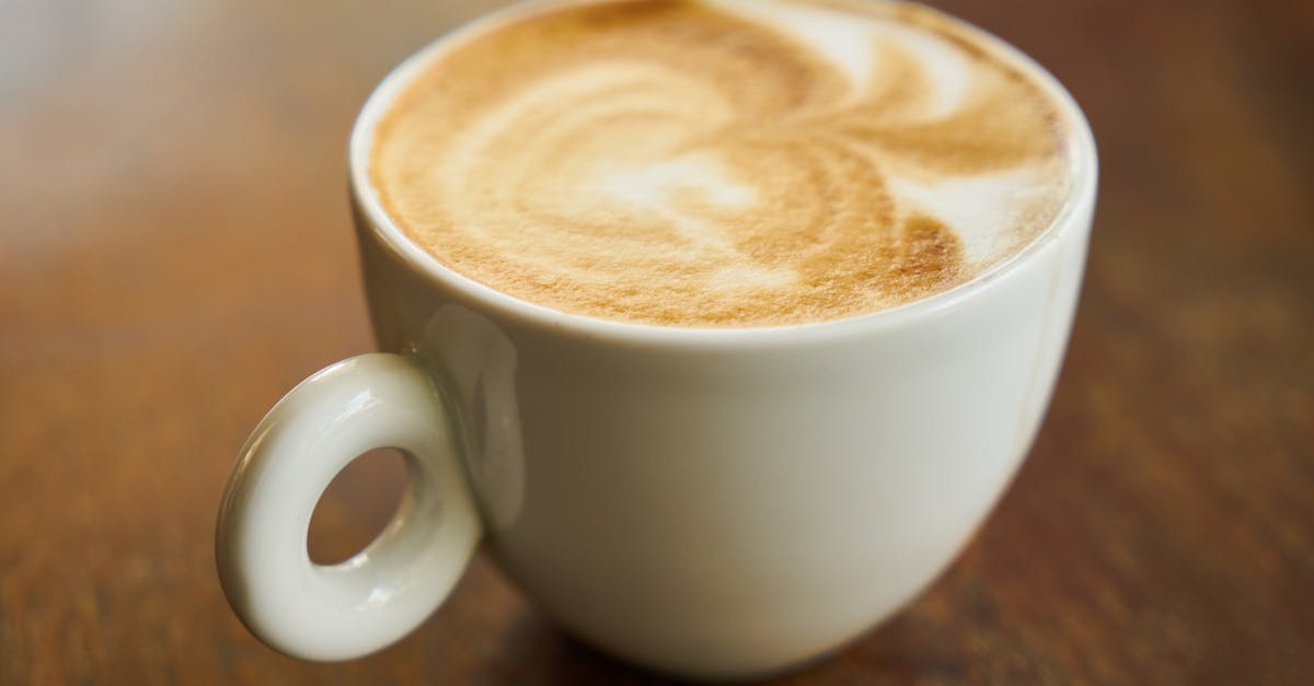What is the white foam that builds up when I make tea? - Filled Cup on Brown Wooden Surface What is the white foam that builds up when I make tea? - Filled Cup on Brown Wooden Surface