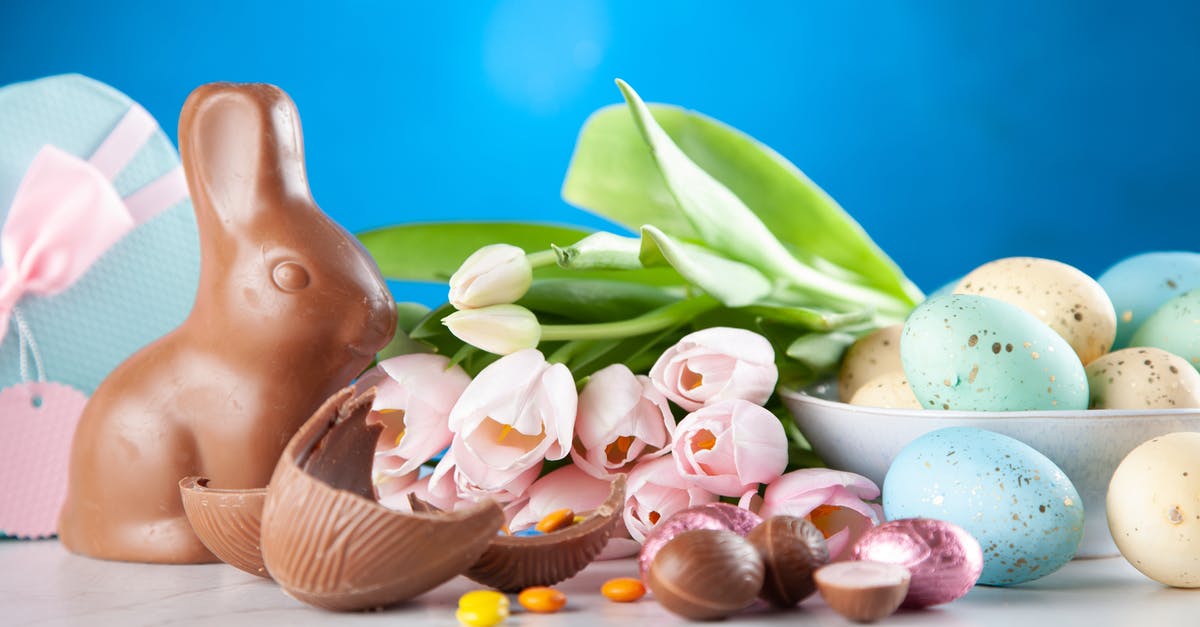 What is this brown mass on this egg? - White Flowers Between Brown Rabbit Figure and Eggs What is this brown mass on this egg? - White Flowers Between Brown Rabbit Figure and Eggs