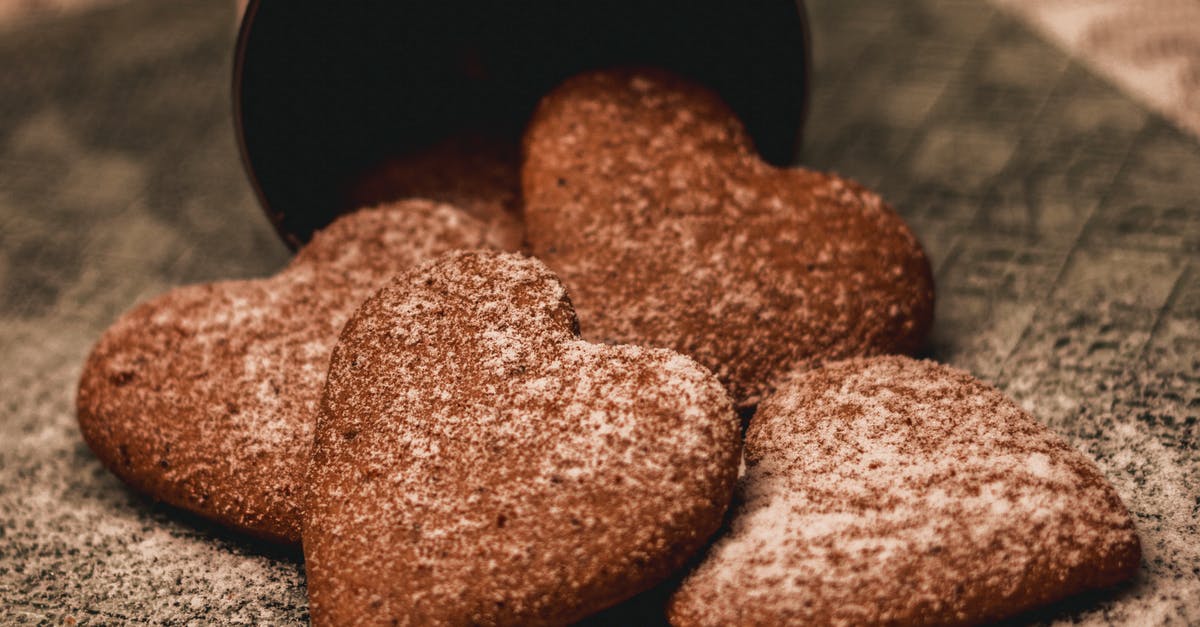 What is this dipped powder cookie called? - Appetizing heart shaped cookies with sugar powder placed on napkin What is this dipped powder cookie called? - Appetizing heart shaped cookies with sugar powder placed on napkin