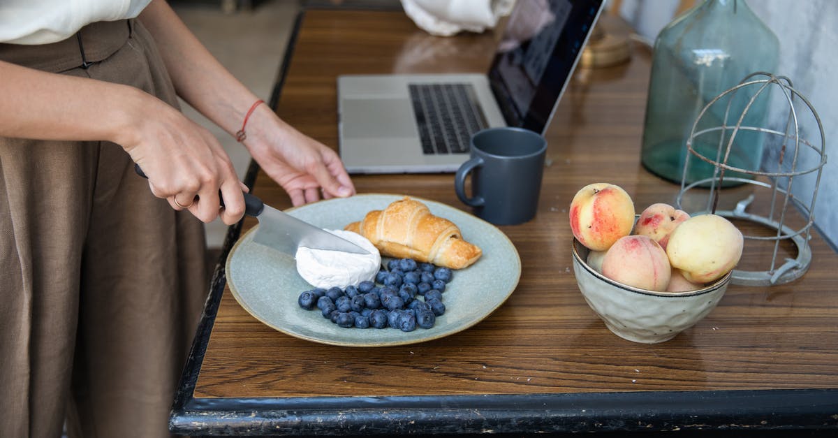 What is this food? - Person Slicing Apple on Brown Wooden Table