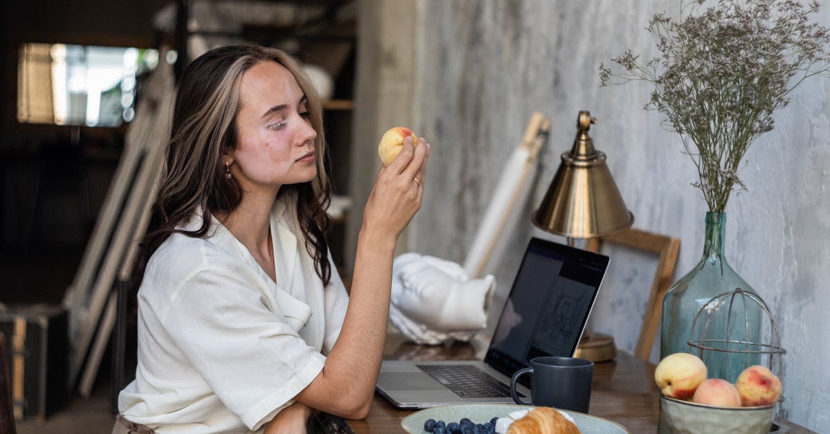 What is this fruit called? - Woman in White Button Up Shirt Sitting by the Table With Fruits on Plate What is this fruit called? - Woman in White Button Up Shirt Sitting by the Table With Fruits on Plate