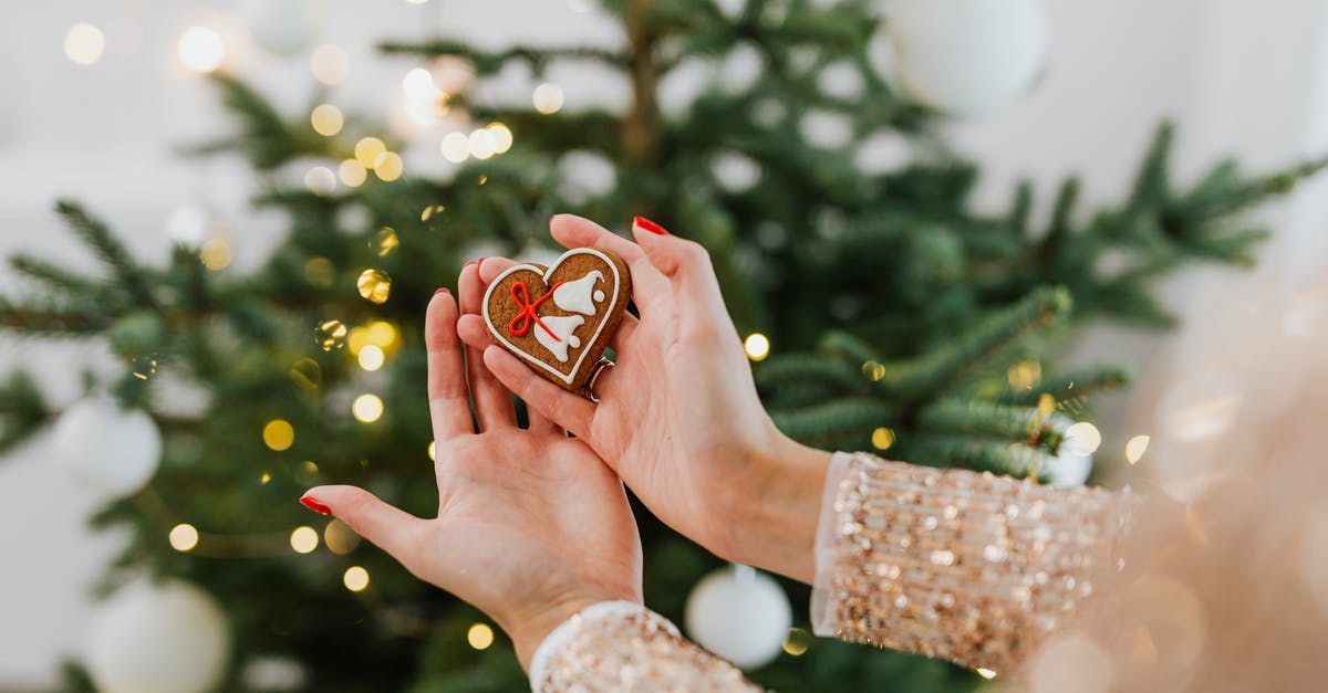 What is this Italian Cookie called? - Person Holding Red and White Heart Ornament