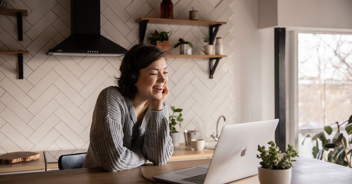 What is this kitchen device? - Young cheerful female smiling and talking via laptop while sitting at wooden table in cozy kitchen What is this kitchen device? - Young cheerful female smiling and talking via laptop while sitting at wooden table in cozy kitchen