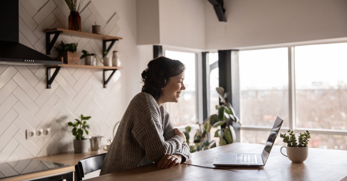 What is this kitchen device? - Happy woman video chatting on laptop in kitchen What is this kitchen device? - Happy woman video chatting on laptop in kitchen