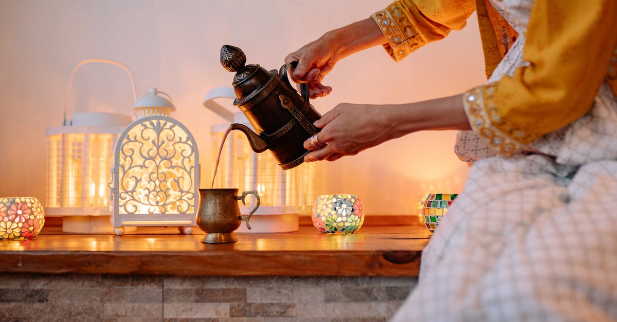 What is this teapot and where can I buy it? - Woman in Yellow Shirt Pouring Tea on Brown Ceramic Teacup What is this teapot and where can I buy it? - Woman in Yellow Shirt Pouring Tea on Brown Ceramic Teacup