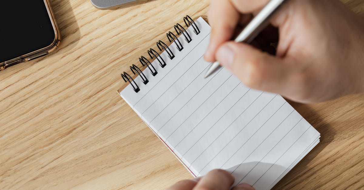 What is this Thai tea, spiral plant-part? - Crop man with pen and opened notebook What is this Thai tea, spiral plant-part? - Crop man with pen and opened notebook